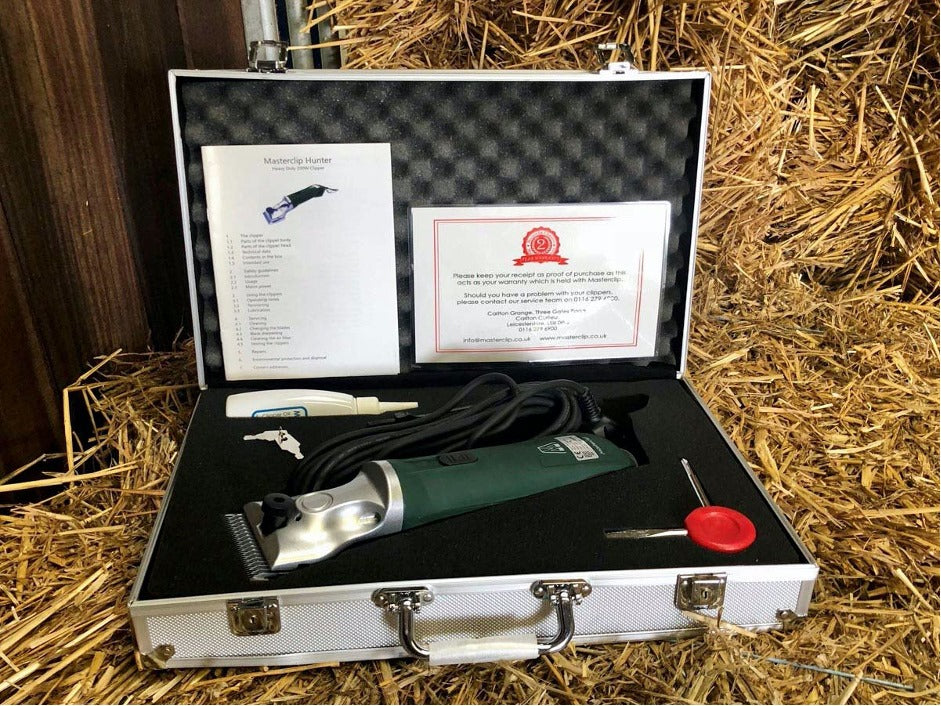 a new green hunter clipper in the carry case on a bed of straw